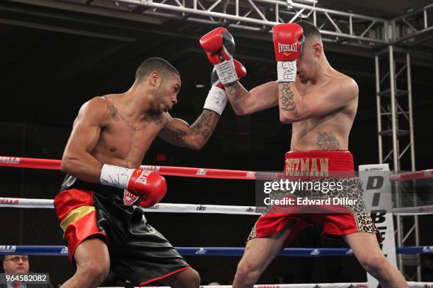 Jonathan Alonso throws a left hand against Jose Guzman at the Hilton Westchester on April 08, 2015 in Rye Brook, New York. Guzman was unable to...