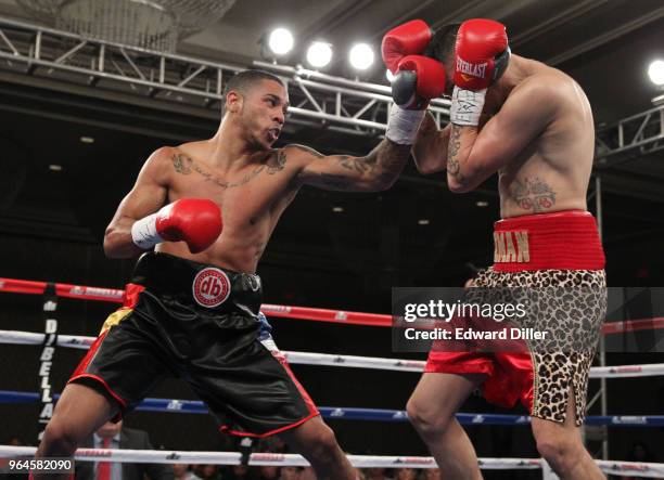 Jonathan Alonso throws a left hand against Jose Guzman at the Hilton Westchester on April 08, 2015 in Rye Brook, New York. Guzman was unable to...