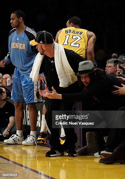 Cisco Adler dives for a loose ball at the game between the Denver Nuggets and the Los Angeles Lakers at Staples Center on February 5, 2010 in Los...