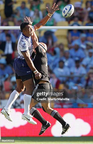 Forbes captain of New Zealand jumps for the ball with Simaika Mikaele of Samoa in the Semi Final Cup match between New Zealand and Samoa during day...