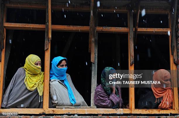 Kashmiris watch the funeral of Zahid Farooq in Srinagar on February 6, 2010. Farooq died on February 5, 2010 after an altercation broke-out between...