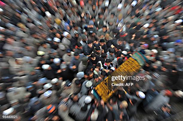 Kashmiri mourners carry the body of Zahid Farooq at his funeral in Srinagar on February 6, 2010. Farooq died on February 5, 2010 after an altercation...