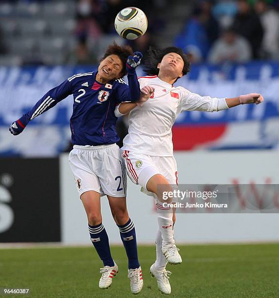 Yukari Kinga of Japan and Yuan Xu of China compete for the ball during the East Asian Football Federation Women's Football Championship 2010 match...