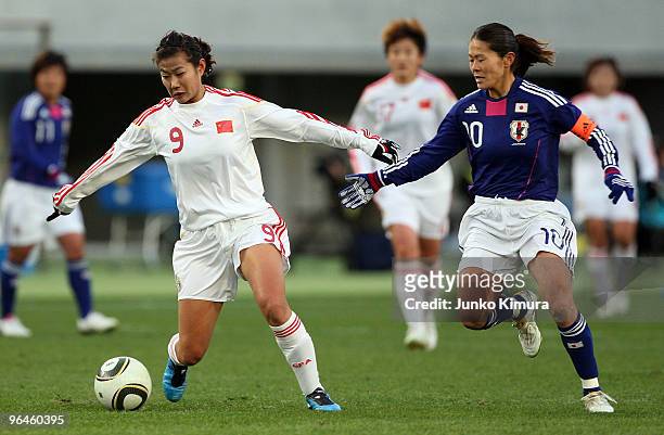 Homare Sawa of Japan and Duan Han of China compete for the ball during the East Asian Football Federation Women's Football Championship 2010 match...