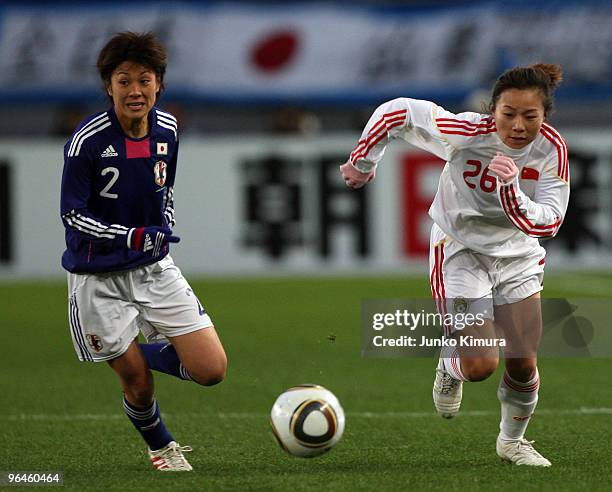 Yukari Kinga of Japan and Lingling Wang of China compete for the ball during the East Asian Football Federation Women's Football Championship 2010...