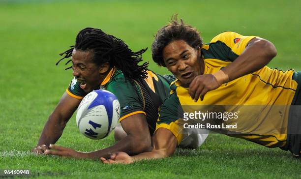 Benjamin Afrika of South Africa and Bracken Karuria-Henry of Australia compete for the ball in the plate final match between South Africa and...