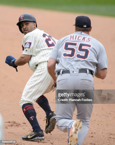 Eddie Rosario of the Minnesota Twins is caught in a rundown as John Hicks of the Detroit Tigers gives chase during the game on May 23, 2018 at Target...