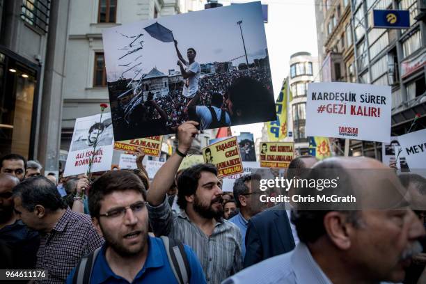 Protestors hold posters and shout slogans during a protest marking the fifth anniversary of the Gezi Park protests on Istiklal street on May 31, 2018...