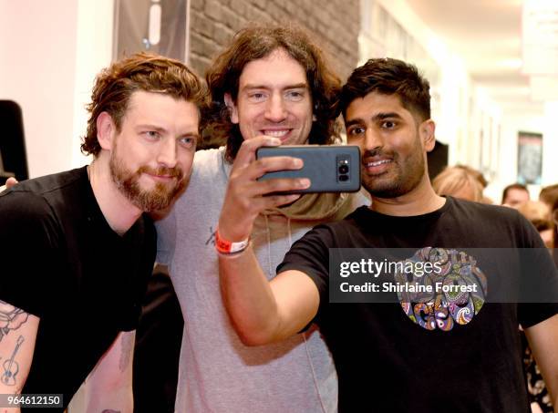 Nathan Connolly and Gary Lightbody of Snow Patrol during an in-store signing and performance of their new album 'Wildness' at HMV Manchester on May...