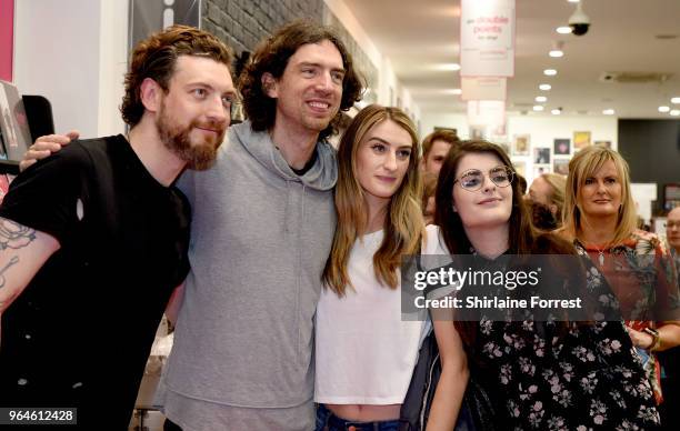 Nathan Connolly and Gary Lightbody of Snow Patrol during an in-store signing and performance of their new album 'Wildness' at HMV Manchester on May...