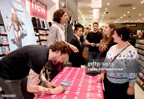 Nathan Connolly and Gary Lightbody of Snow Patrol during an in-store signing and performance of their new album 'Wildness' at HMV Manchester on May...