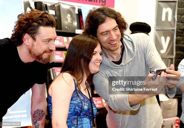 Nathan Connolly and Gary Lightbody of Snow Patrol during an in-store signing and performance of their new album 'Wildness' at HMV Manchester on May...