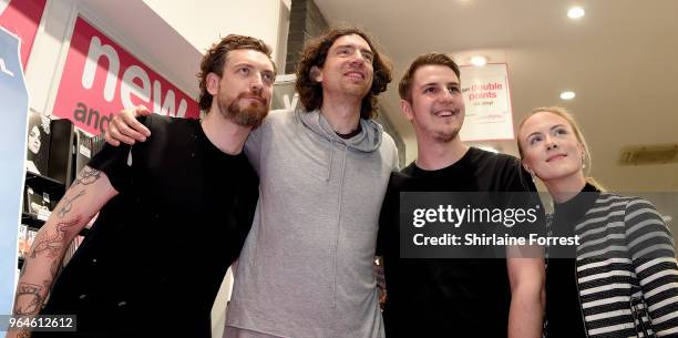 Nathan Connolly and Gary Lightbody of Snow Patrol during an in-store signing and performance of their new album 'Wildness' at HMV Manchester on May...