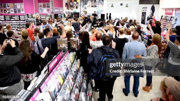 Gary Lightbody and Nathan Connolly of Snow Patrol during an in-store signing and performance of their new album 'Wildness' at HMV Manchester on May...