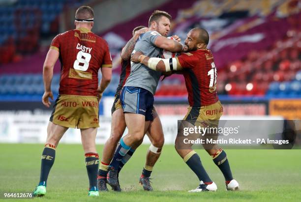 Huddersfield Giants' Paul Clough is tackled by Catalan Dragons' Sam Moa during the Ladbrokes Challenge Cup, quarter final match at the John Smith's...