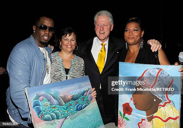 Rapper Sean "Diddy" Combs, Debra Lee, Chairman & CEO of BET, former President Bill Clinton, and actress Queen Latifah look at Haitian paintings...