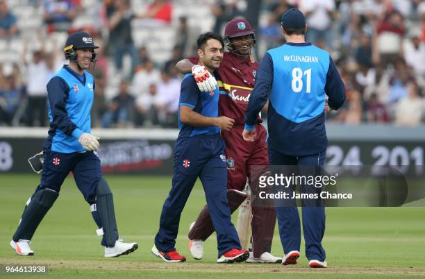 Marlon Samuels of the West Indies speaks to Rashid Khan of the ICC World XI and Mitchell McClenaghan of the ICC World XI during the Hurricane Relief...