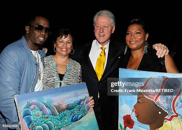 Rapper Sean "Diddy" Combs, Debra Lee, Chairman & CEO of BET, former President Bill Clinton, and actress Queen Latifah look at Haitian paintings...