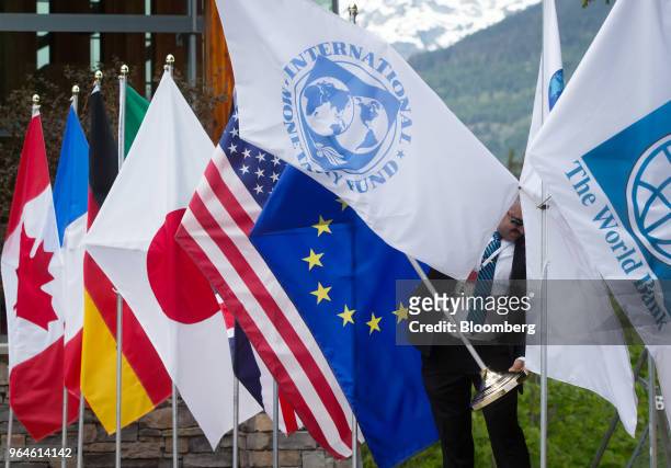 Security guard adjusts an International Monetary Fund flag during the G7 finance ministers and central bank governors meeting in Whistler, British...