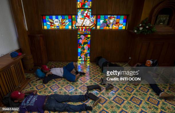 Peasants who spent the night at the Metropolitan Cathedral in Managua, where they took refuge during deadly clashes after a march marking Nicaragua's...