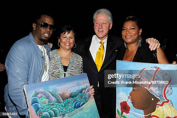 Rapper Sean "Diddy" Combs, Debra Lee, Chairman & CEO of BET, former President Bill Clinton, and actress Queen Latifah look at Haitian paintings...