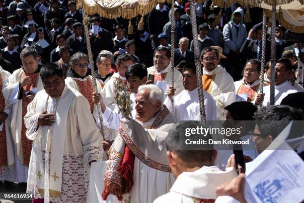 Priest Nicola Girasoli leads a procession as Corpus Christi is celebrated in Plaza De Armas on May 31, 2018 in Cusco, Peru. Thousands of members of...