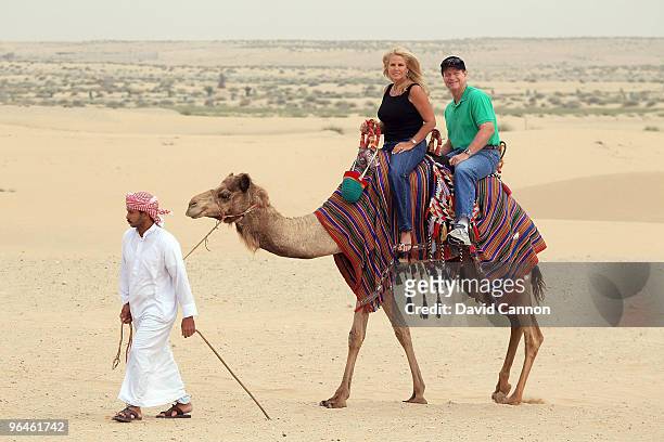 Tom Watson of the USA as his wife Hilary Watson take a ride on a camel during their visit to the Jumeirah Bab Al Shams Desert Resort after his second...