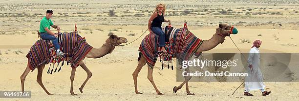 Tom Watson of the USA and his wife Hilary Watson take a ride on a camel during their visit to the Jumeirah Bab Al Shams Desert Resort after his...