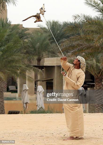 Falconer working with the falcon during a falconry demonstration during the visit of Tom Watson of the USA visit to the Bab Al Sham Resort after his...