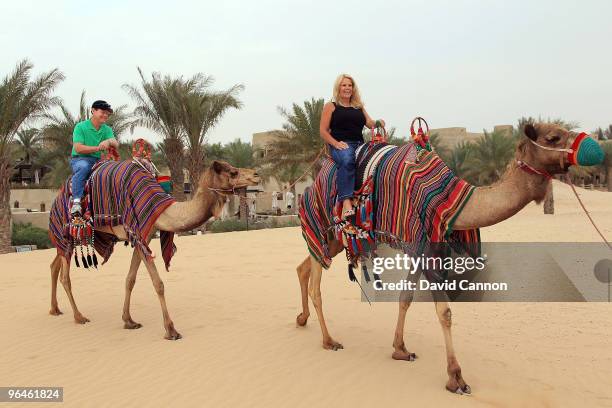 Tom Watson of the USA and his wife Hilary Watson take a ride on a camel during their visit to the Jumeirah Bab Al Shams Desert Resort after his...