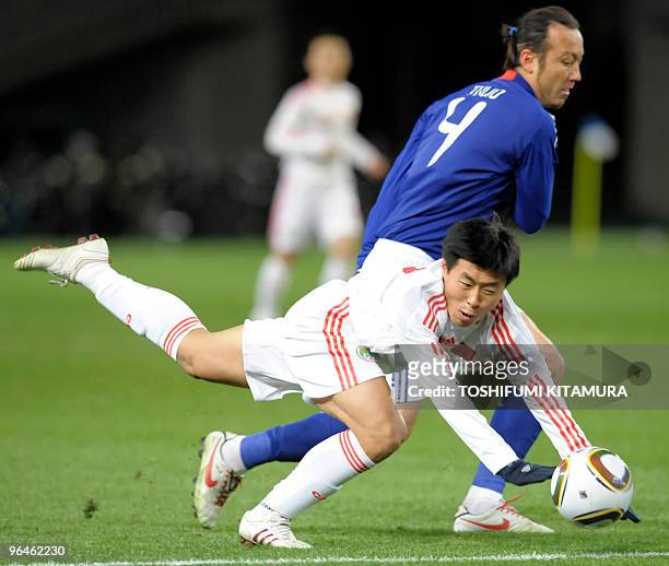 China's midfielder Jiang Ning is fouled by Japan's defender Marcus Tulio Tanaka during the first half of the East Asian Football Championships 2010...