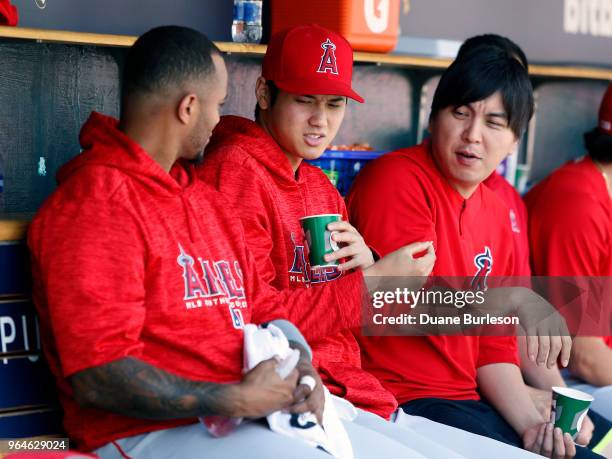 Shohei Ohtani of the Los Angeles Angels of Anaheim talks with Martin Maldonado of the Los Angeles Angels of Anaheim and interpreter Ippei Mizuhara...
