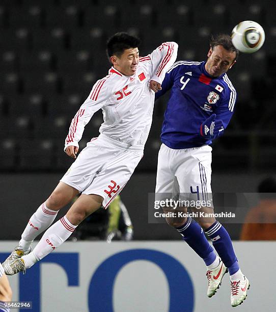 Marcus Tulio Tanaka of Japan and Xu Yang of China compete for the ball during the East Asian Football Championship 2010 match between Japan and China...