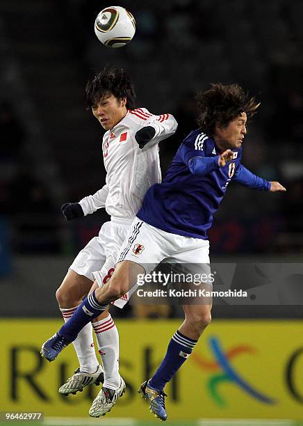 Yasuhito Endo of Japan and Zhuoxiang Deng of China compete for the ball during the East Asian Football Championship 2010 match between Japan and...