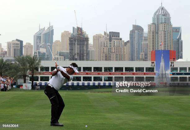 Thongchai Jaidee of Thailand plays his second shot at the 18th hole during the third round of the 2010 Omega Dubai Desert Classic on the Majilis...