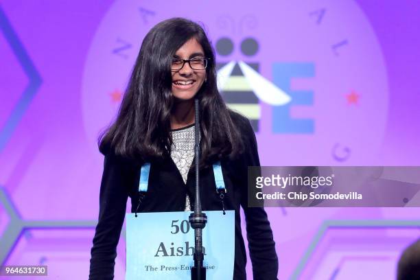 Aisha Randhawa correctly spells the word 'arrhostia' during the final rounds of the 91st Scripps National Spelling Bee at the Gaylord National Resort...