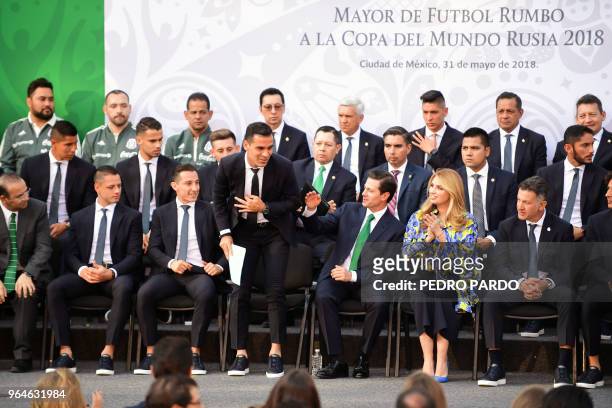 Mexican President Enrique Pena Nieto gestures next to Mexico's national football team player Rafael Marquez his wife Angelica Rivera , the Mexico's...