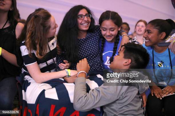Tara Singh is embraced by friends and fellow supporters after she misspelled the word 'vinhatico' during the final rounds of the 91st Scripps...