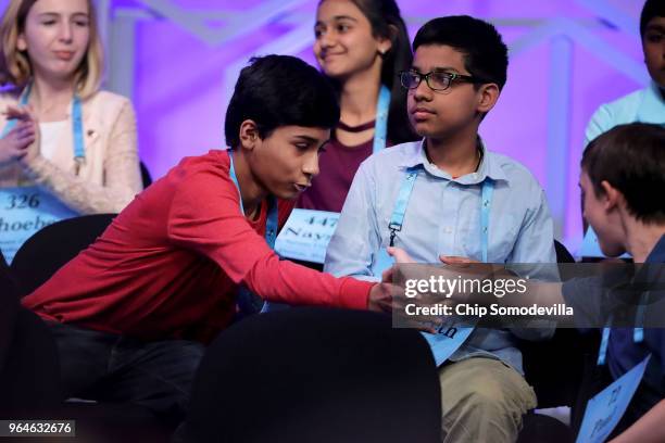 Jashun Paluru is congratulated by his fellow contestants after correctly spelling the word 'chaitya' during the final rounds of the 91st Scripps...