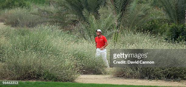 Edoardo Molinari of Italy walks to his second shot at the 16th hole during the third round of the 2010 Omega Dubai Desert Classic on the Majilis...