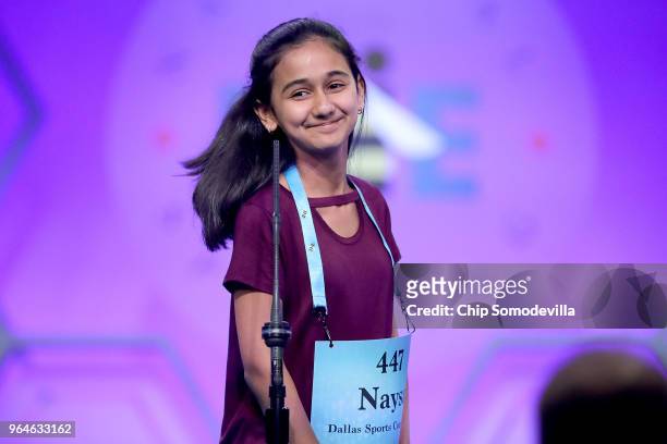 Naysa Modi smiles after correctly spelling the word 'telyn' during the final rounds of the 91st Scripps National Spelling Bee at the Gaylord National...