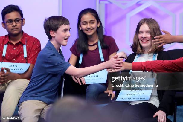 Paul Hamrick is congratulated by his fellow competitors after successfully spells the word 'binnacle' during the final rounds of the 91st Scripps...