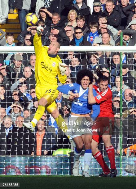 Pepe Reina of Liverpool punches the ball away from Sotirios Kyrgiakos of Liverpool and Marouane Fellaini of Everton during the Barclays Premier...