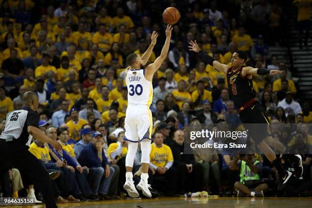 Stephen Curry of the Golden State Warriors shoots a three pointer over Jordan Clarkson of the Cleveland Cavaliers in Game 1 of the 2018 NBA Finals at...