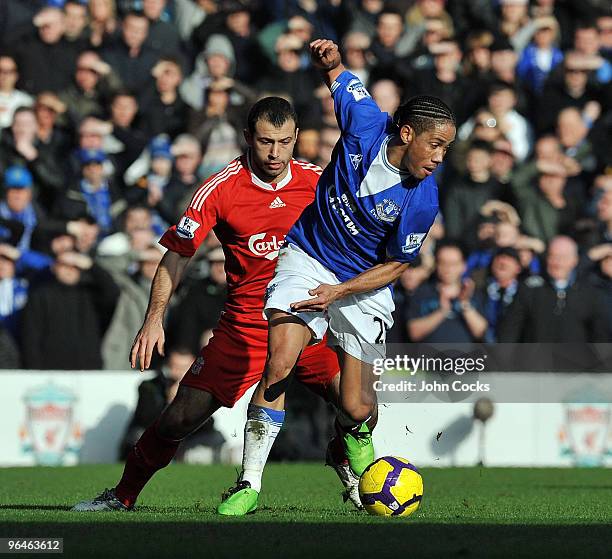 Javier Mascherano of Liverpool competes with Steven Pienaar of Everton during the Barclays Premier League match between Liverpool and Everton at...