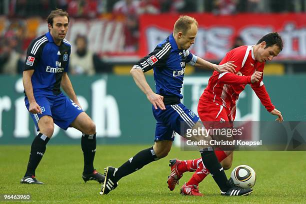 David Jarolim of Hamburg challenges Sebastian Freis of Köln during the Bundesliga match between 1. FC Koeln and Hamburger SV at the...