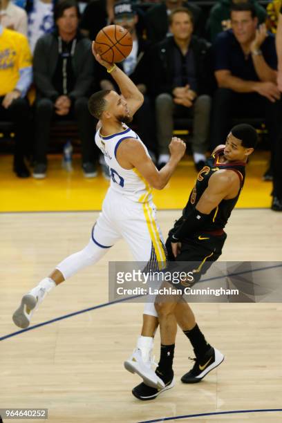 Stephen Curry of the Golden State Warriors shoots over Jordan Clarkson of the Cleveland Cavaliers in Game 1 of the 2018 NBA Finals at ORACLE Arena on...