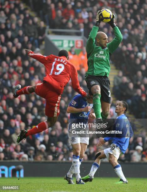 Tim Howard of Everton leaps to claim the ball under pressure from Ryan Babel of Liverpool during the Barclays Premier League match between Liverpool...