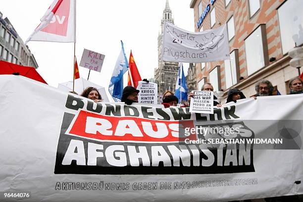 Protestors taking part in a demonstration against the 46th Munich Security Conference hold up a banner whivh reads "German Army out of Afghanistan"...