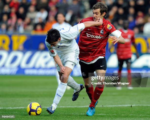 Julian Schuster of Freiburg battles for the ball with Christoph Moritz of Schalke during the Bundesliga match between SC Freiburg and FC Schalke 04...